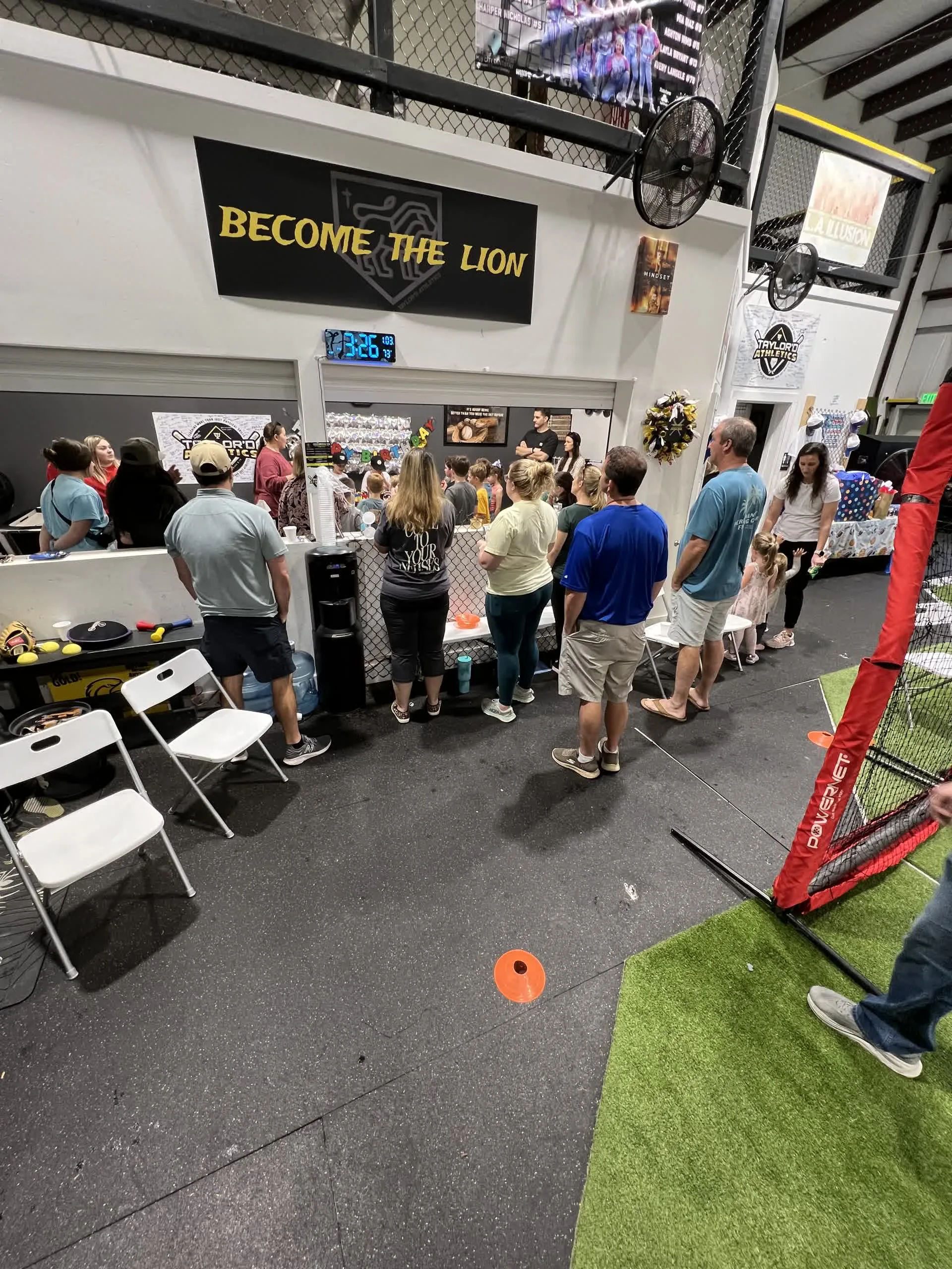 Birthday party setup inside the Taylor'd Athletics facility with tables and chairs