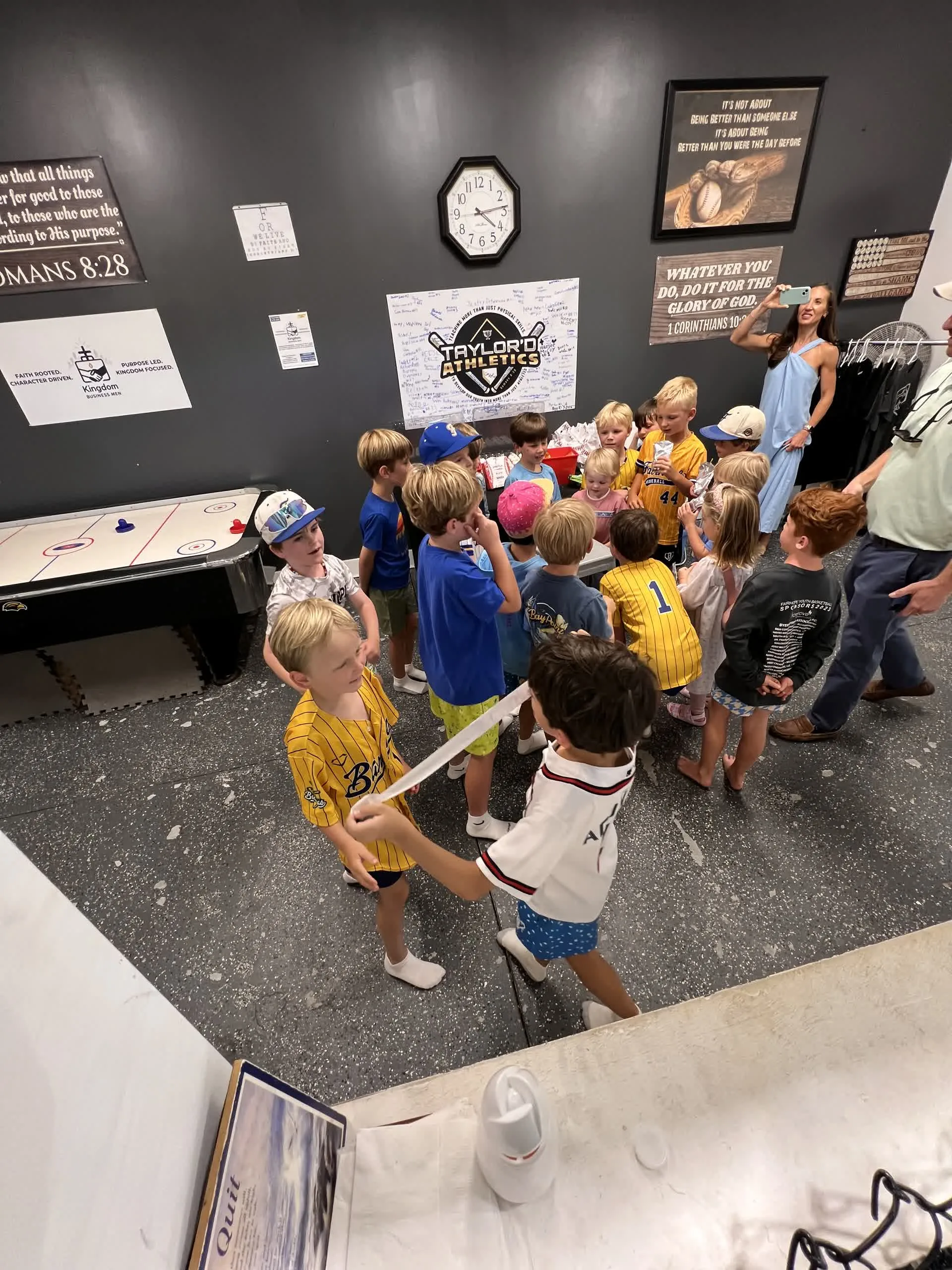 Overhead view of kids arriving and gathering for a birthday party at Taylor'd Athletics