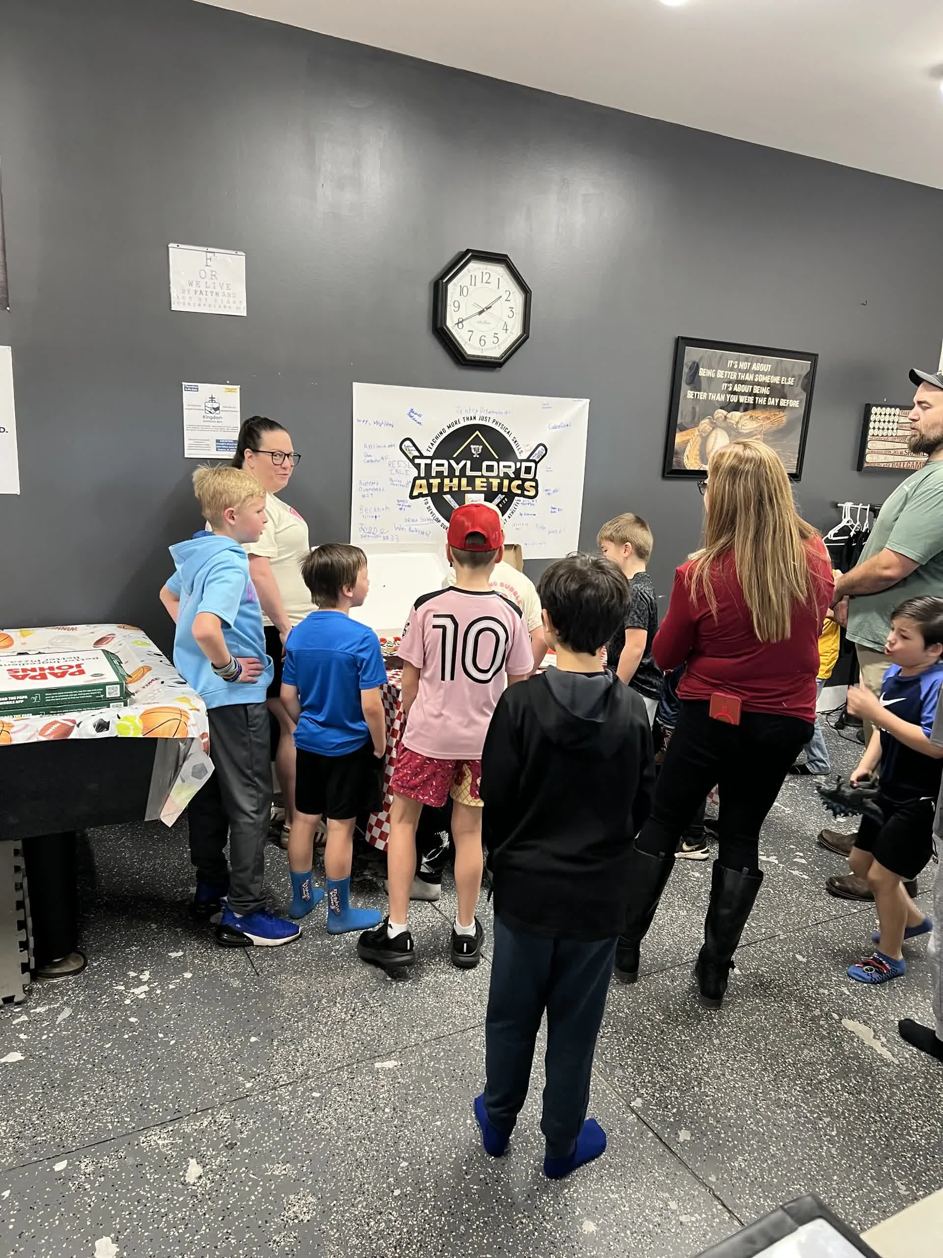 Kids gathered around a table during birthday party activities