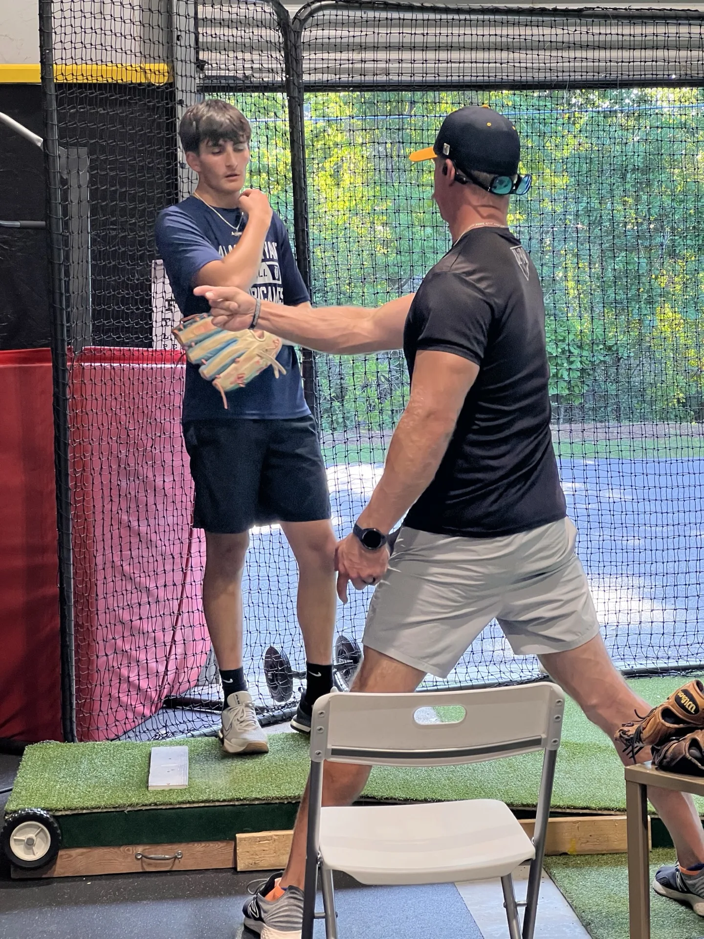 Coach correcting a player's batting stance