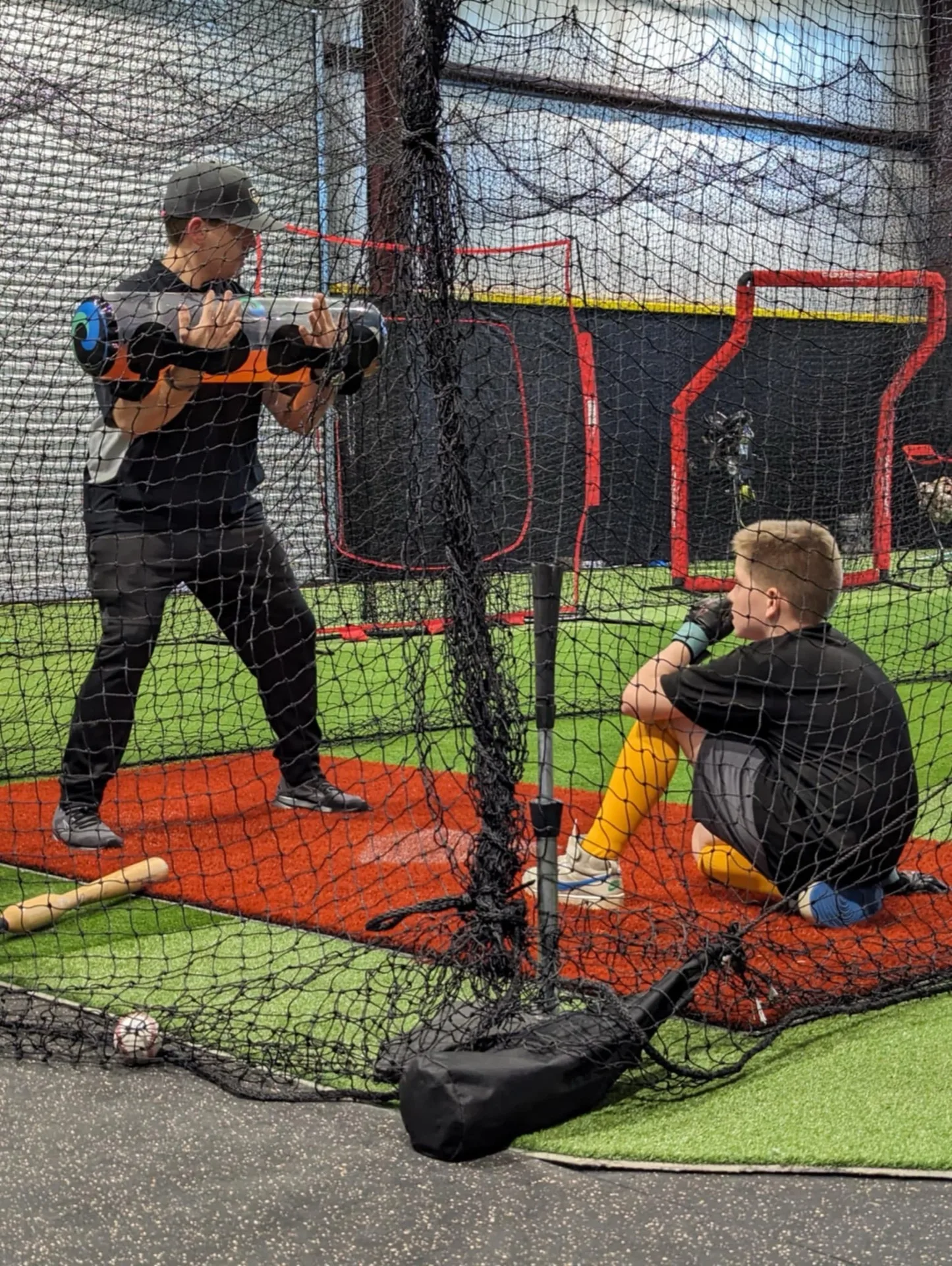 Coach demonstrating proper swing mechanics