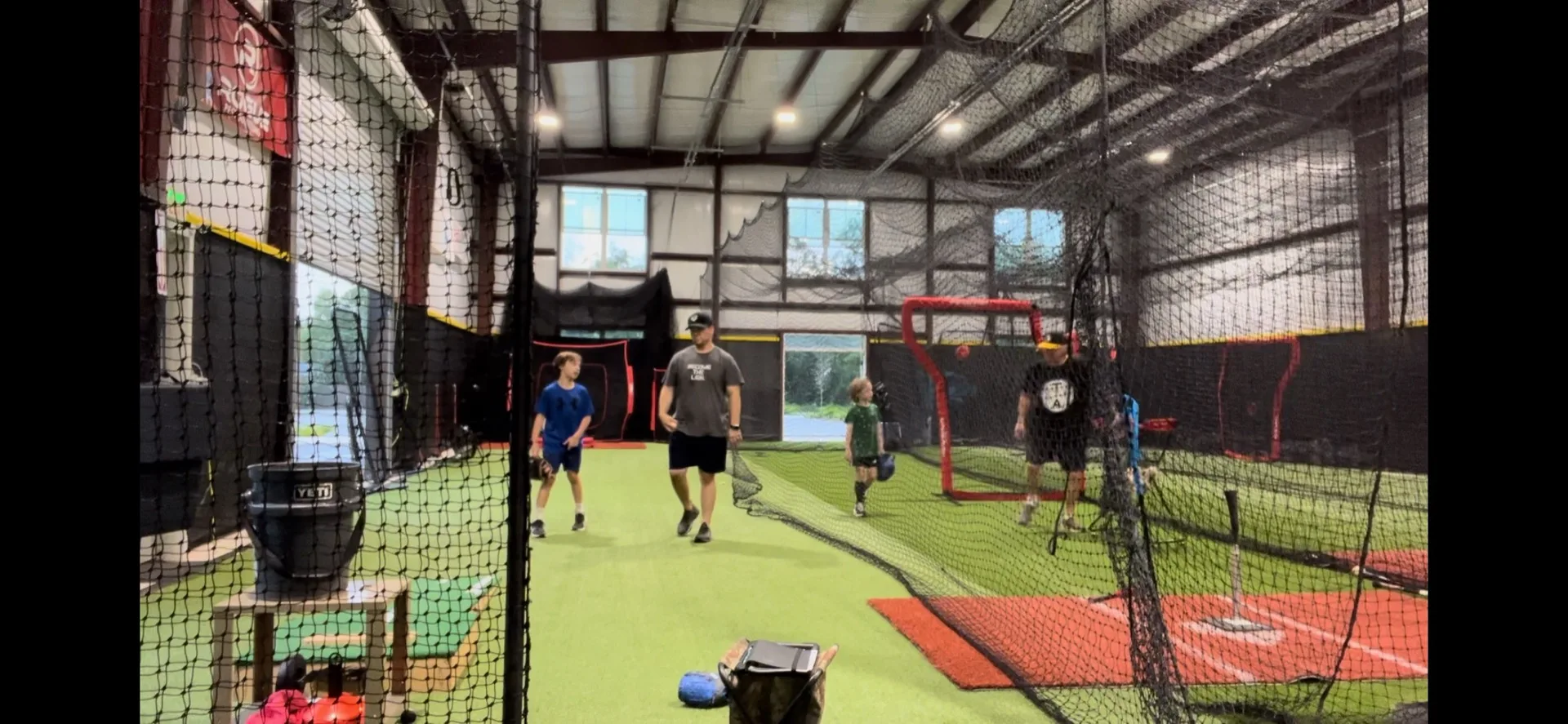 Coach and player walking through a drill together in the facility