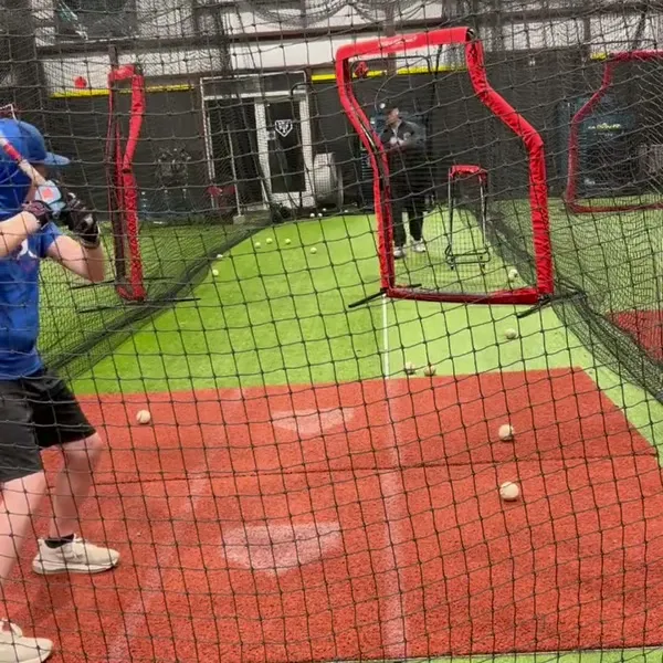 Wide facility view of batting session
