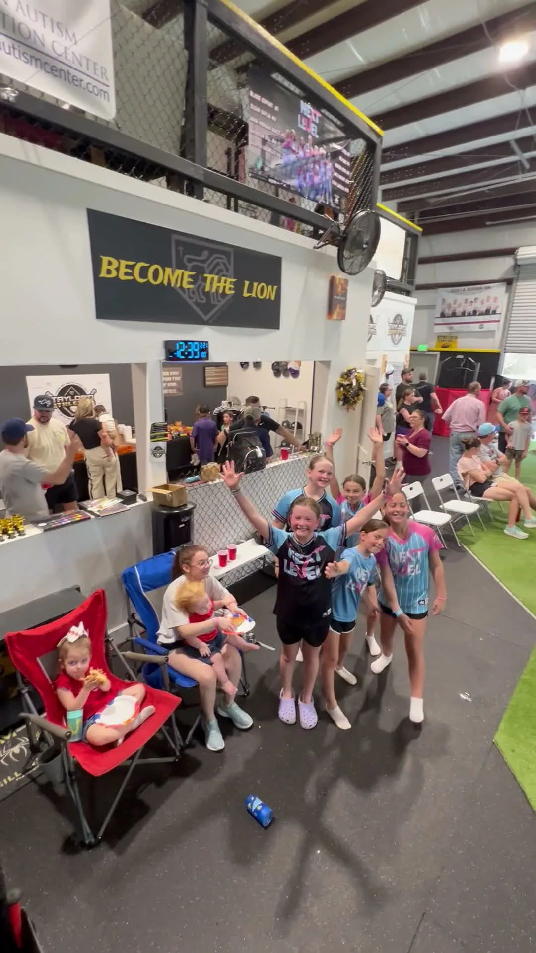 Girls celebrating and cheering at a birthday party under the Become the Lion sign