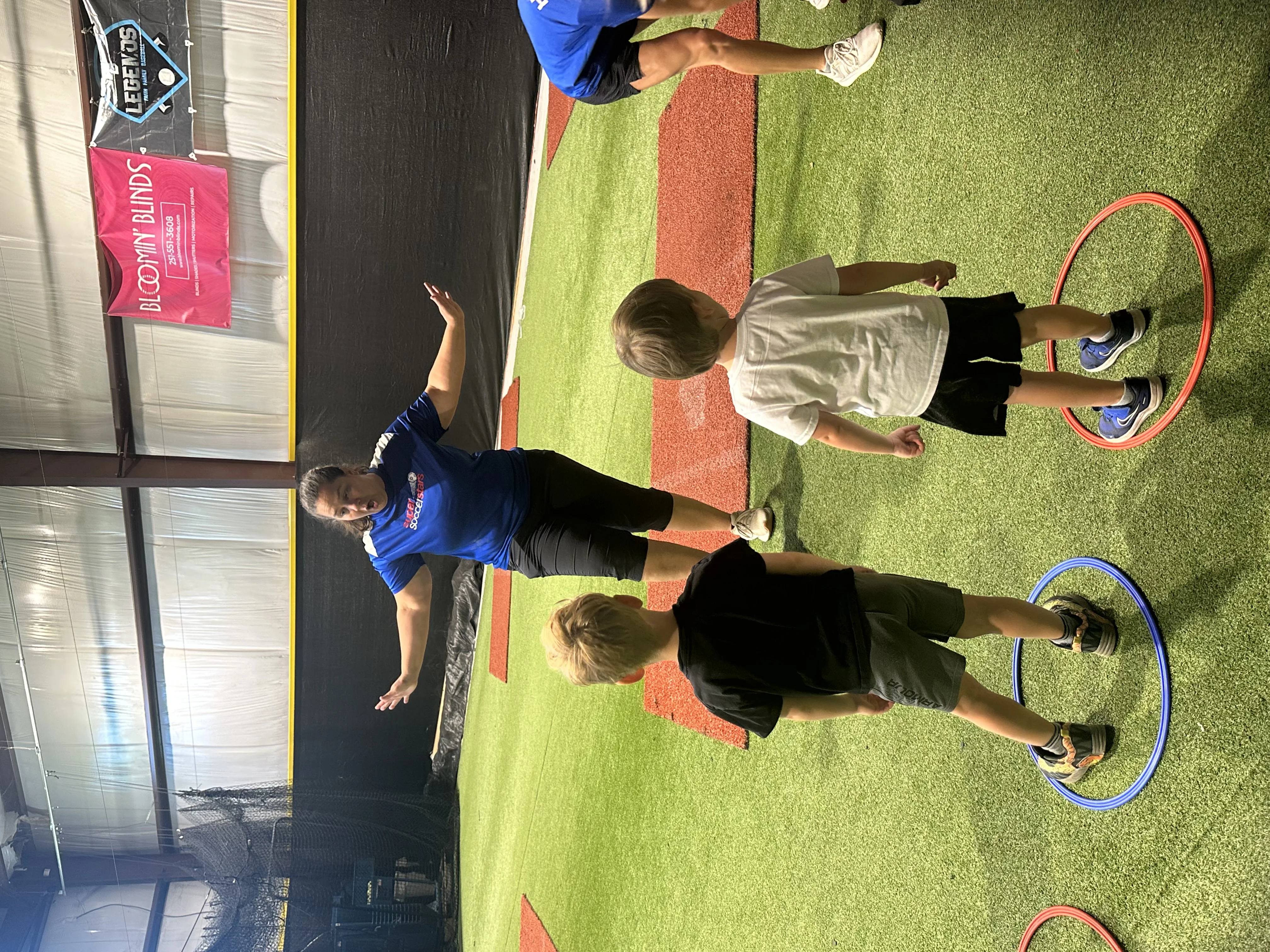 Soccer Stars coach directing kids through hoop agility drills