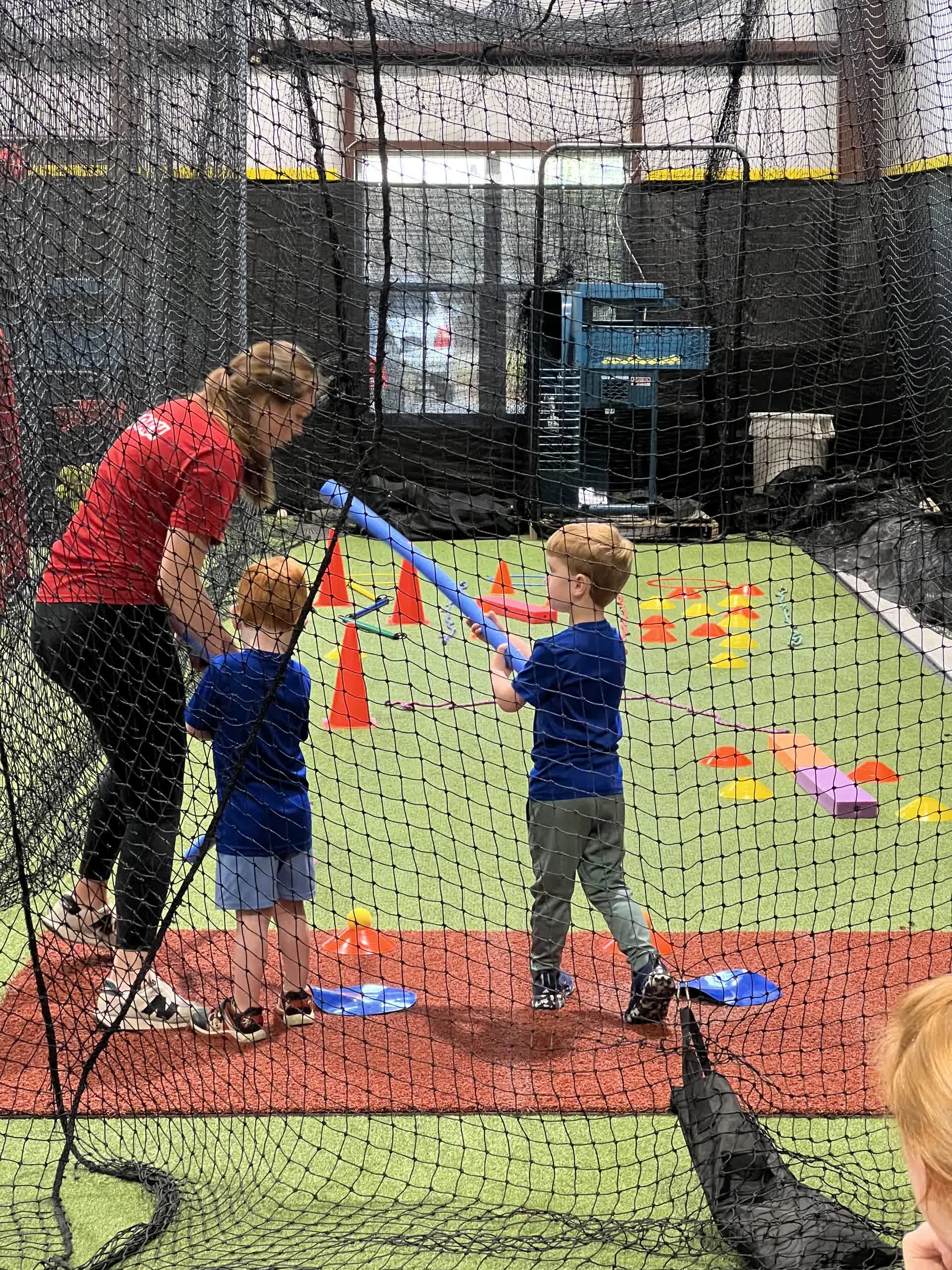 Coach instructing toddlers during a soccer session in the facility